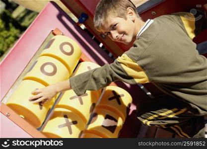 Portrait of a boy playing tic-tac-toe