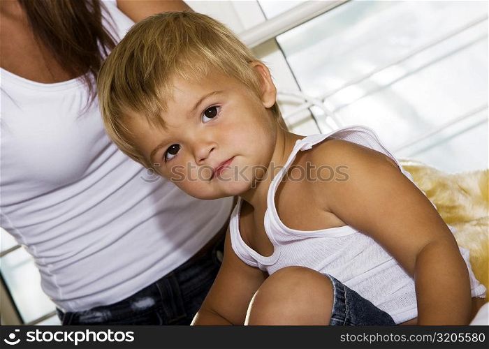 Portrait of a boy sitting on his mother&acute;s lap