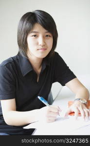 Portrait of a boy smiling and writing