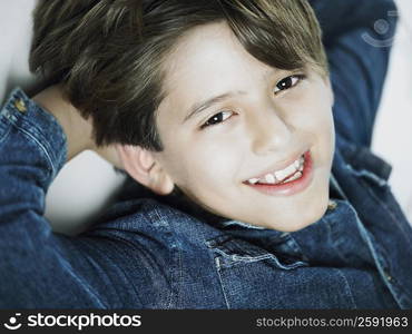 Portrait of a boy smiling with his hands in his hair