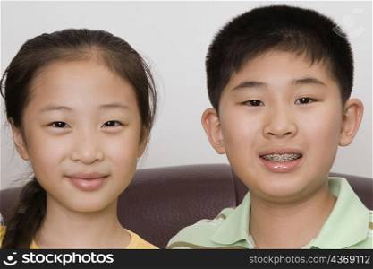 Portrait of a boy smiling with his sister