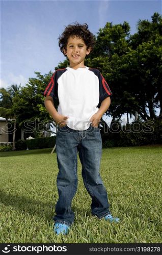 Portrait of a boy standing in a lawn