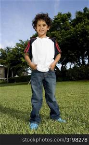 Portrait of a boy standing in a lawn