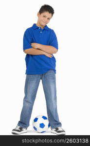 Portrait of a boy standing with a soccer ball