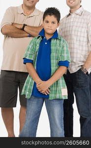 Portrait of a boy standing with his father and grandfather