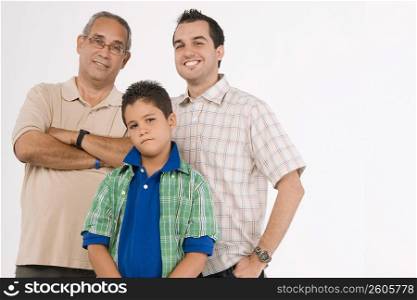 Portrait of a boy standing with his father and grandfather