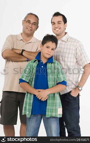 Portrait of a boy standing with his father and grandfather