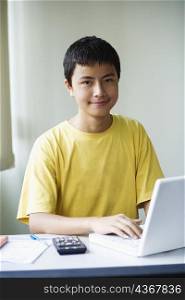 Portrait of a boy using a laptop