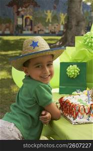 Portrait of a boy wearing a cowboy hat at a birthday party