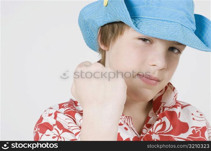 Portrait of a boy wearing a hat and looking confident