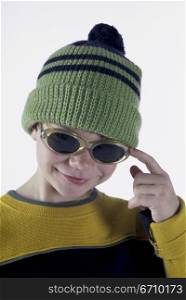 Portrait of a boy wearing a hat and sunglasses