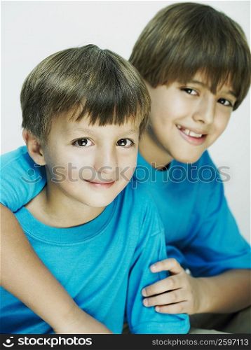 Portrait of a boy with his arm over his brother