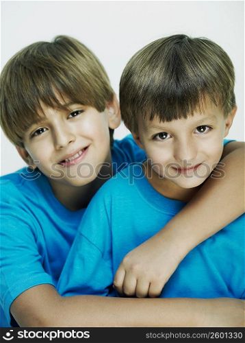 Portrait of a boy with his arm over his brother