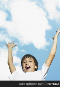 Portrait of a boy with his arms raised