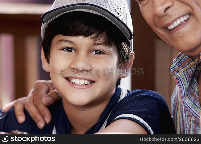 Portrait of a boy with his grandfather smiling