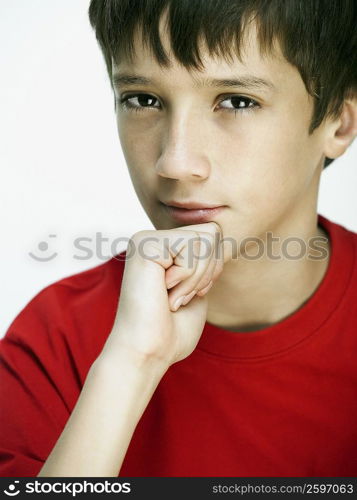 Portrait of a boy with his hand on his chin