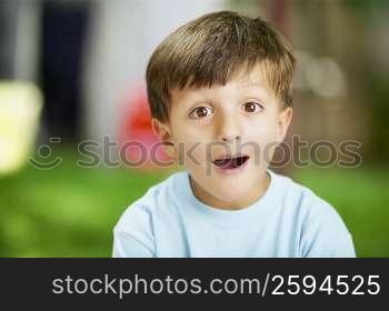 Portrait of a boy with his mouth open