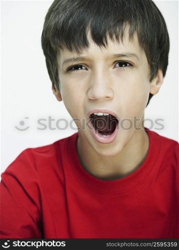 Portrait of a boy yawning