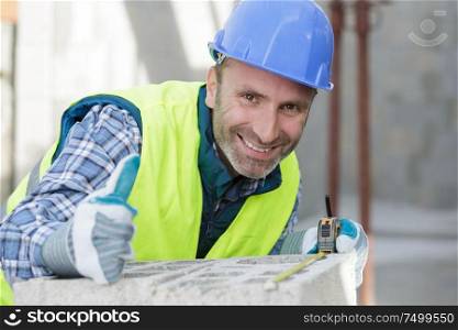portrait of a bricklayer with spirit level