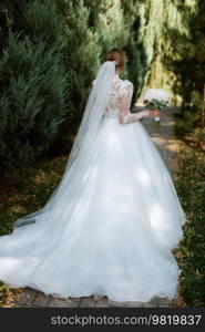 portrait of a bride in the morning before the wedding with putting on a white dress