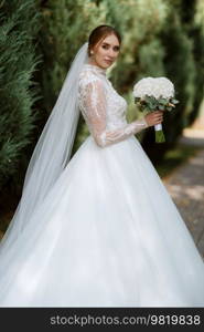 portrait of a bride in the morning before the wedding with putting on a white dress