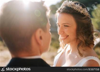 Portrait of a bride looking at her husband and smiling