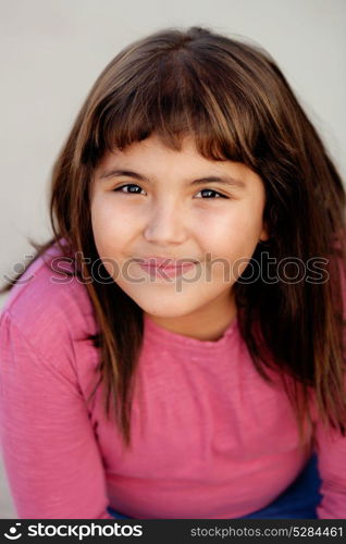 Portrait of a brunette preteen girl with pink t-shirt