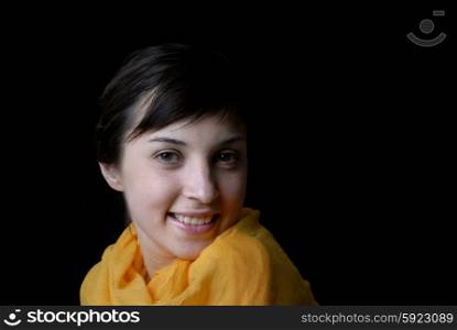 Portrait of a brunette young girl in black background
