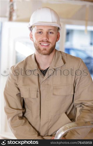 portrait of a builder in overalls