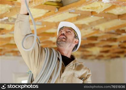 portrait of a builder installing pipes