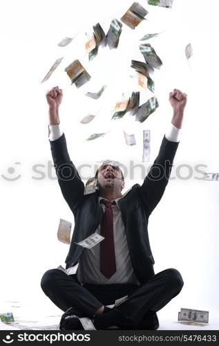 Portrait of a business man holding and catch falling money bills, isolated on white background in studio