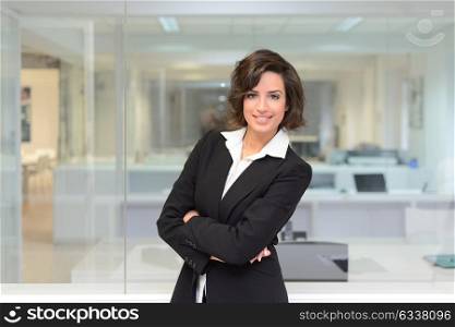 Portrait of a business woman in a office. Crossed arms