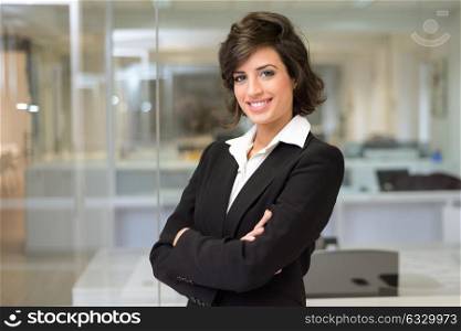 Portrait of a business woman in an office. Crossed arms