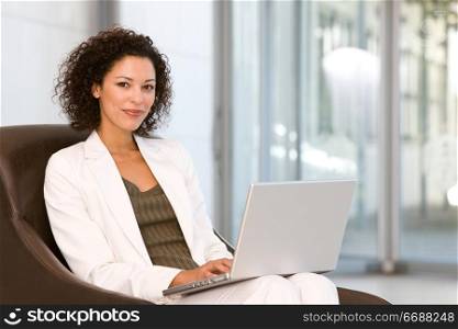 portrait of a business woman sitting with laptop