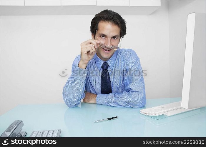 Portrait of a businessman adjusting his eyeglasses