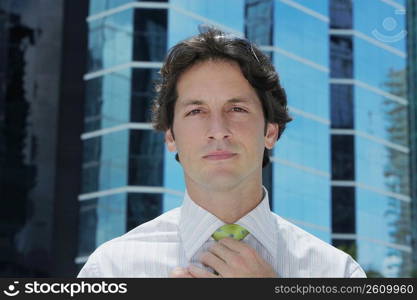 Portrait of a businessman adjusting his tie