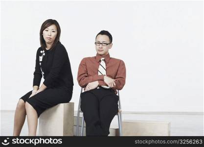 Portrait of a businessman and a businesswoman sitting