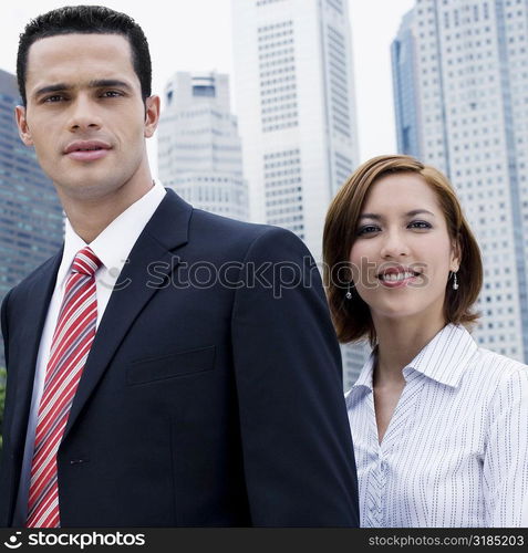 Portrait of a businessman and a businesswoman smiling