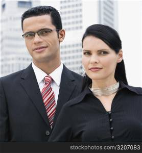 Portrait of a businessman and a businesswoman smirking