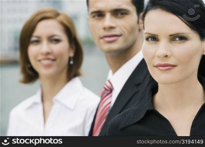 Portrait of a businessman and two businesswomen