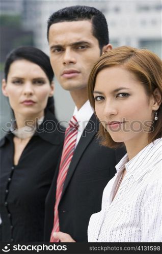 Portrait of a businessman and two businesswomen in a row