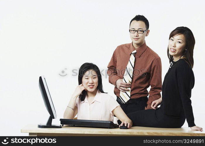 Portrait of a businessman and two businesswomen smiling