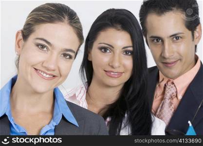 Portrait of a businessman and two businesswomen smiling