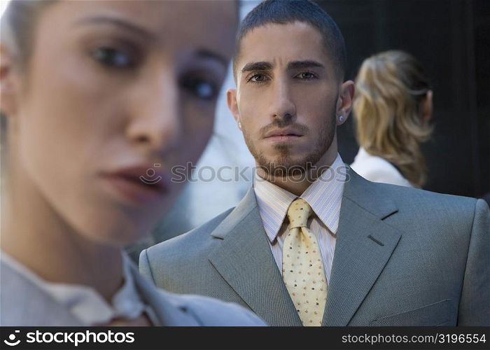 Portrait of a businessman between two businesswomen