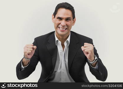 Portrait of a businessman cheering