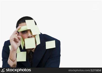 Portrait of a businessman covered with adhesive notes