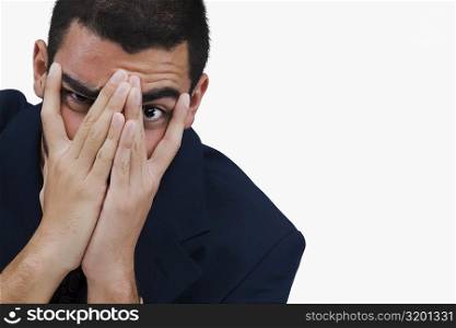 Portrait of a businessman covering his face with his hands