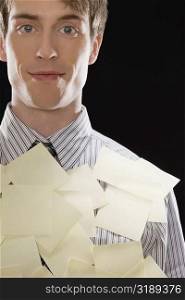 Portrait of a businessman covering with adhesive notes