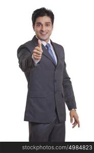 Portrait of a businessman giving thumbs up