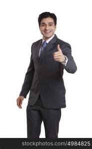 Portrait of a businessman giving thumbs up